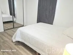 a bedroom with a bed and a mirror