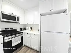 a kitchen with stainless steel appliances a refrigerator sink and microwave