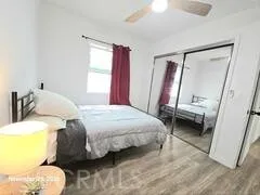 a bedroom with a bed and a mirror