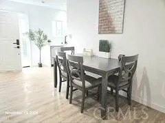 a view of a dining room with furniture and a potted plant