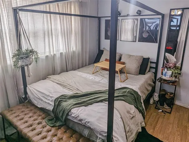 a bedroom with a bed and a window