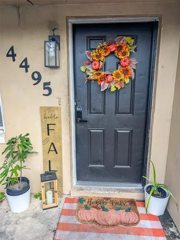 a vase of flowers sitting on a table in front of a door