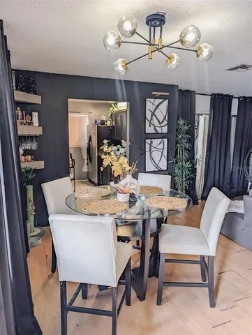 a view of a dining room with furniture and chandelier