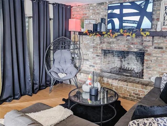 a dining room with fireplace furniture and a rug
