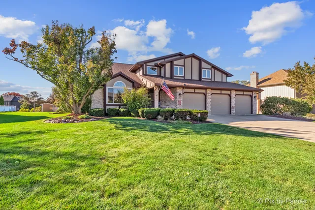 a view of a house with a big yard and large trees
