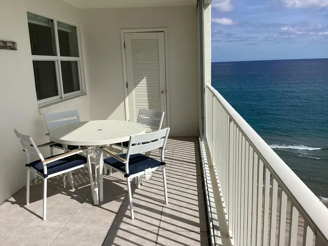 a living room with furniture and a lamp