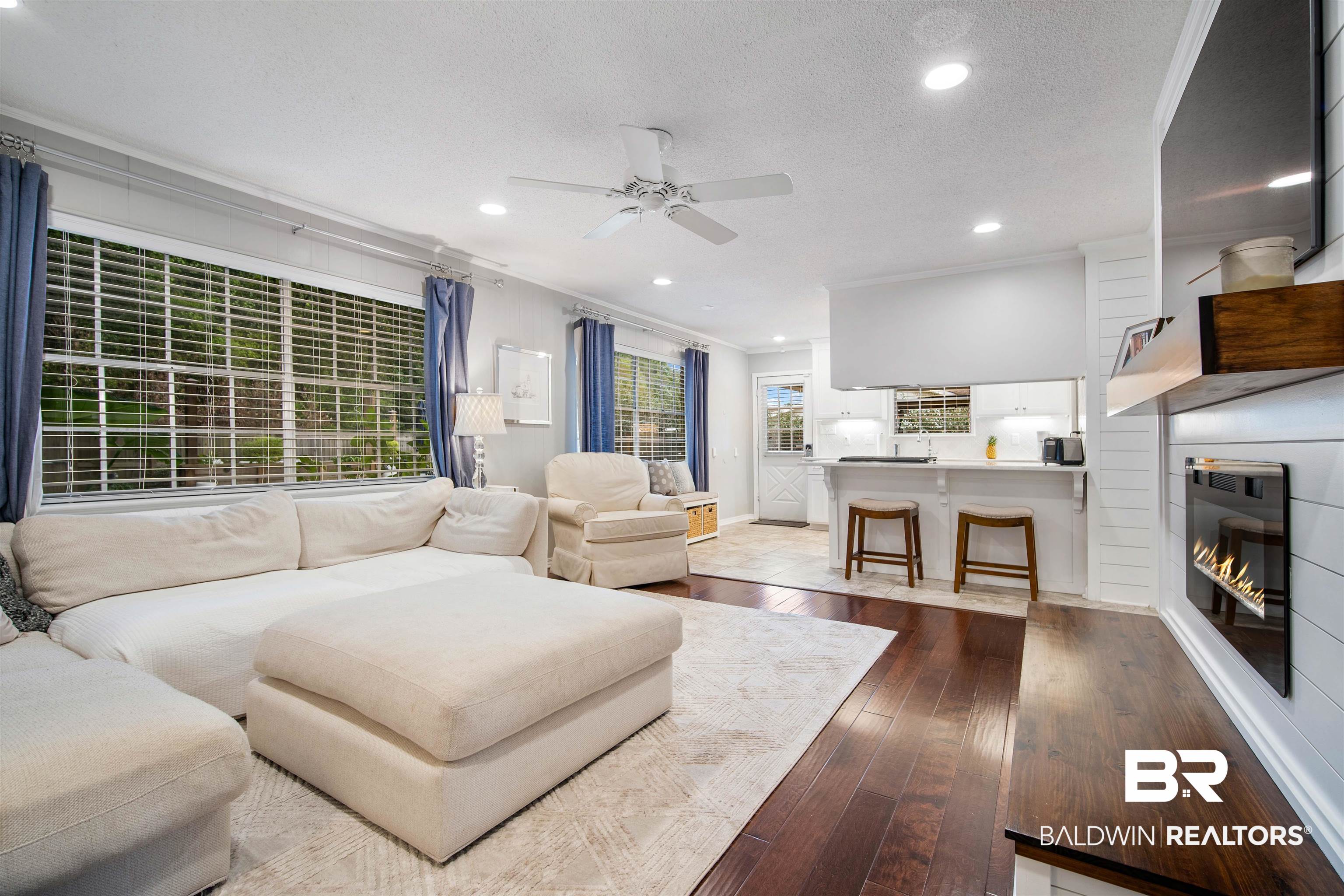 4228 Spring Valley Drive South Mobile, AL 36693 - Photo 6 of 31 Living room with ceiling fan, crown molding, wood-type flooring, and a textured ceiling