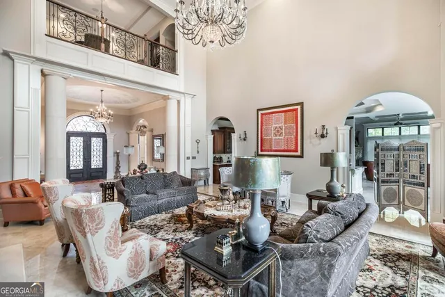 a living room with furniture a flat screen tv and a large window
