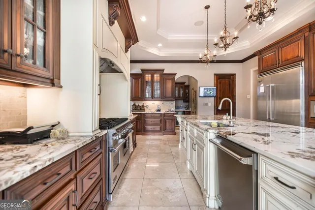 a view of a dining room with furniture and a chandelier