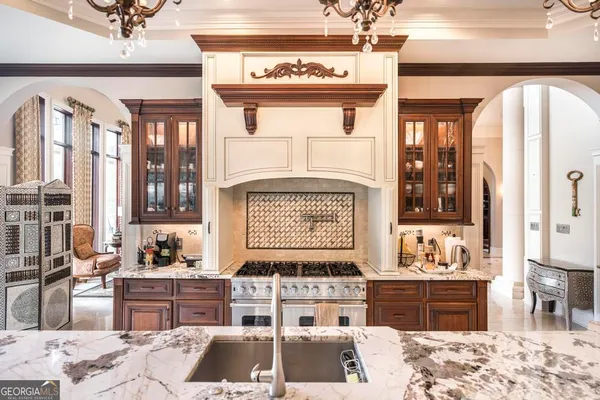 a kitchen with stainless steel appliances granite countertop a stove a sink and a refrigerator