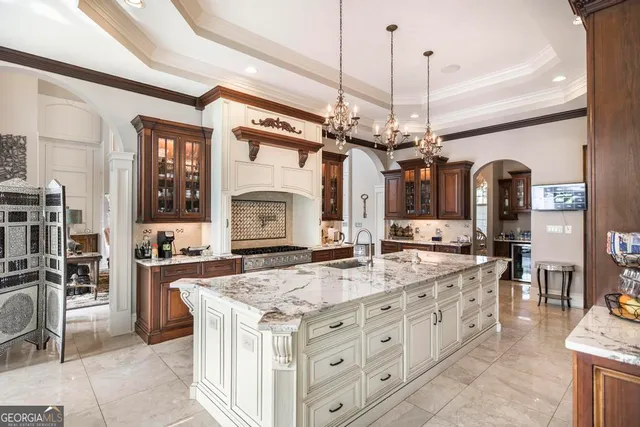 a living room with furniture a chandelier and a rug