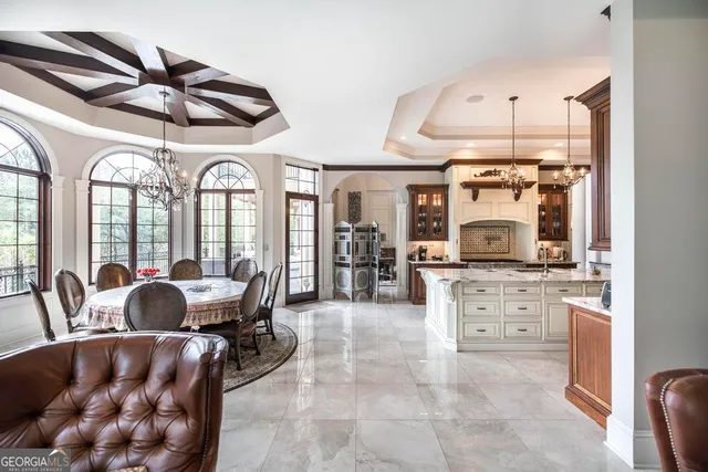 a living room with furniture a flat screen tv and a large window