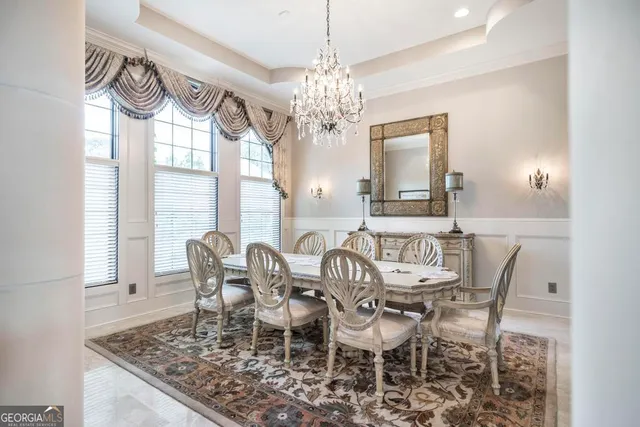 a living room with furniture a wooden floor and a chandelier