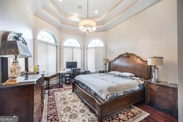 a view of a walk in closet with clothes and shoes