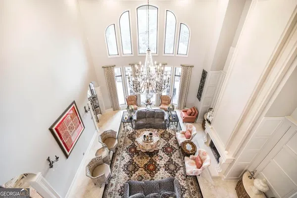 a kitchen with stainless steel appliances granite countertop a refrigerator a stove a sink a dining table and chairs with wooden floor