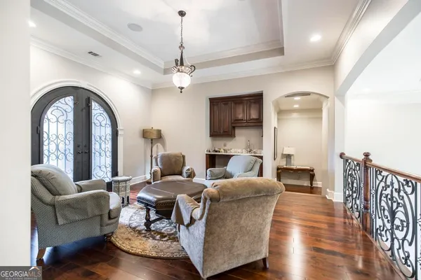 a kitchen with stainless steel appliances granite countertop a stove top oven a sink dishwasher and a refrigerator with wooden cabinets