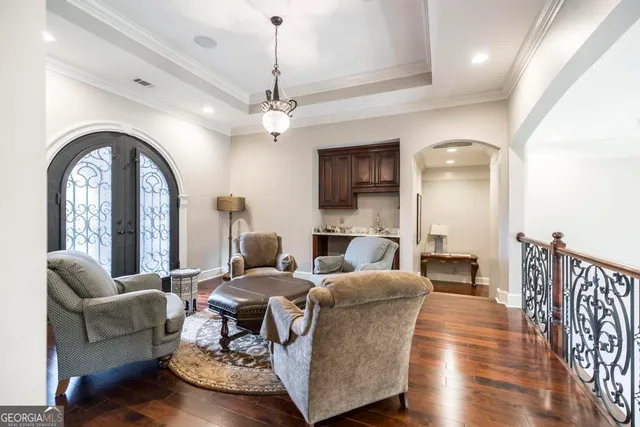 a kitchen with stainless steel appliances granite countertop a stove top oven a sink dishwasher and a refrigerator with wooden cabinets