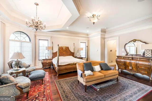 a view of a yard with plants and large trees