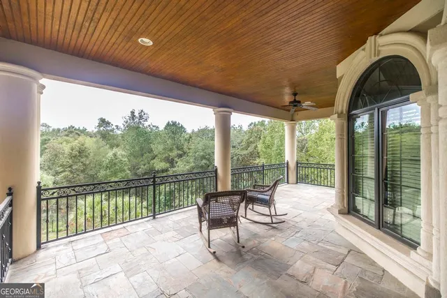 a view of a patio with a table and chairs in a yard