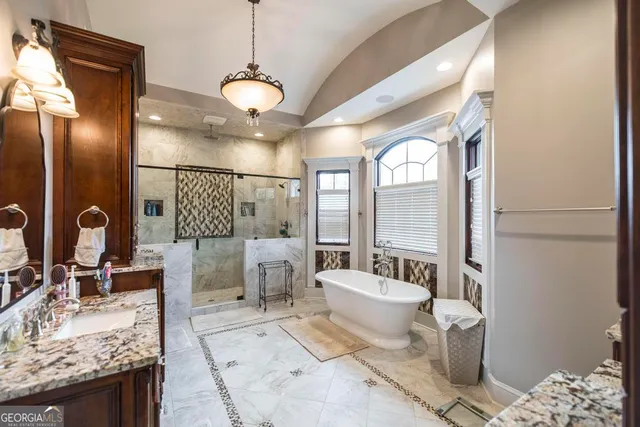 an aerial view of residential houses with outdoor space and trees