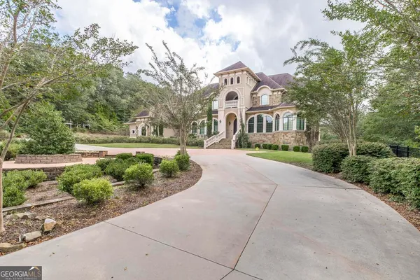 a large bathroom with a granite countertop double vanity sink a mirror and a shower