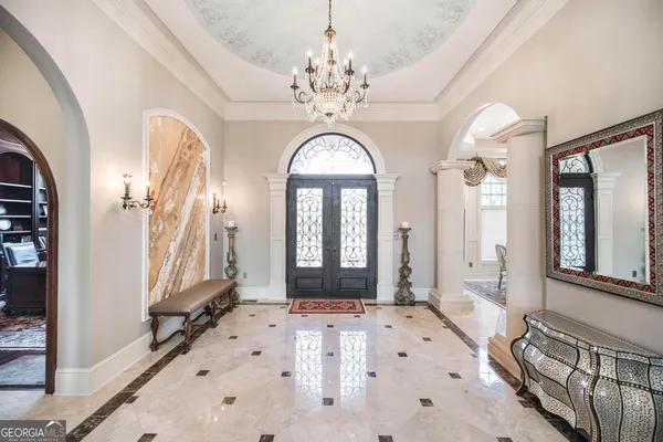 a kitchen with stainless steel appliances granite countertop a refrigerator a stove and a sink with wooden cabinets