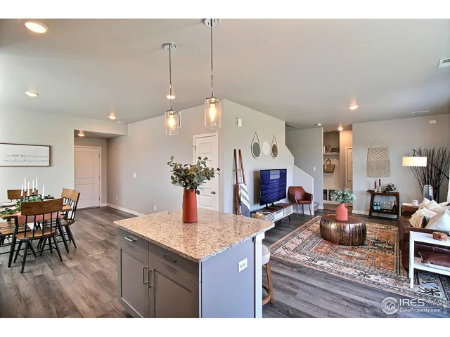 a kitchen with stainless steel appliances kitchen island granite countertop a sink a stove and cabinets