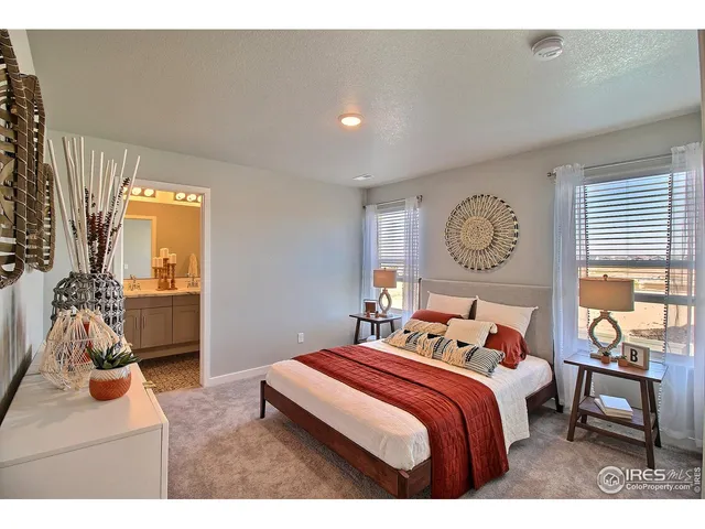 a bathroom with a granite countertop sink a toilet and a mirror