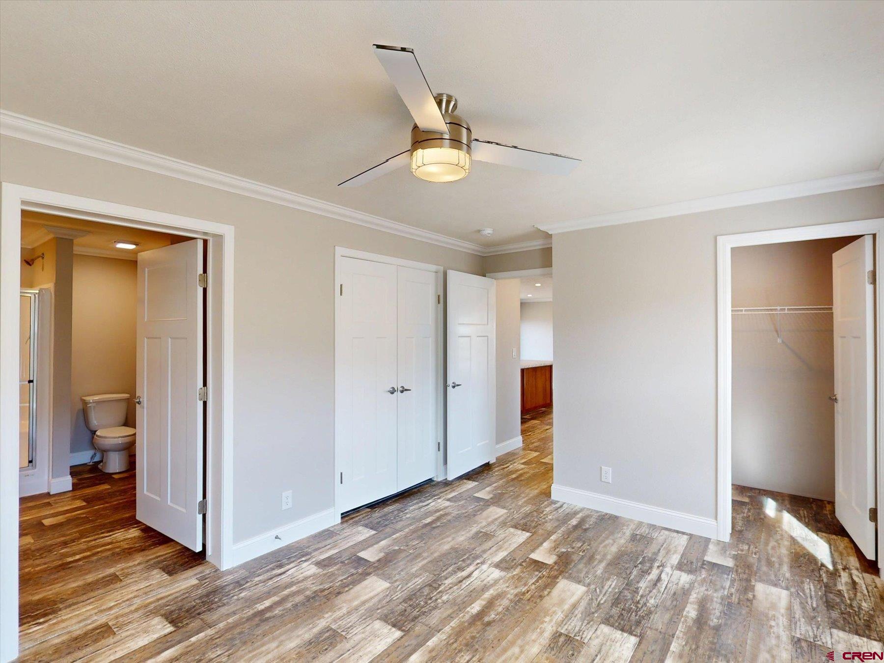 2229 Highway 160 Cortez, CO 81321 - Photo 11 of 32 a view of an empty room with wooden floor and a ceiling fan