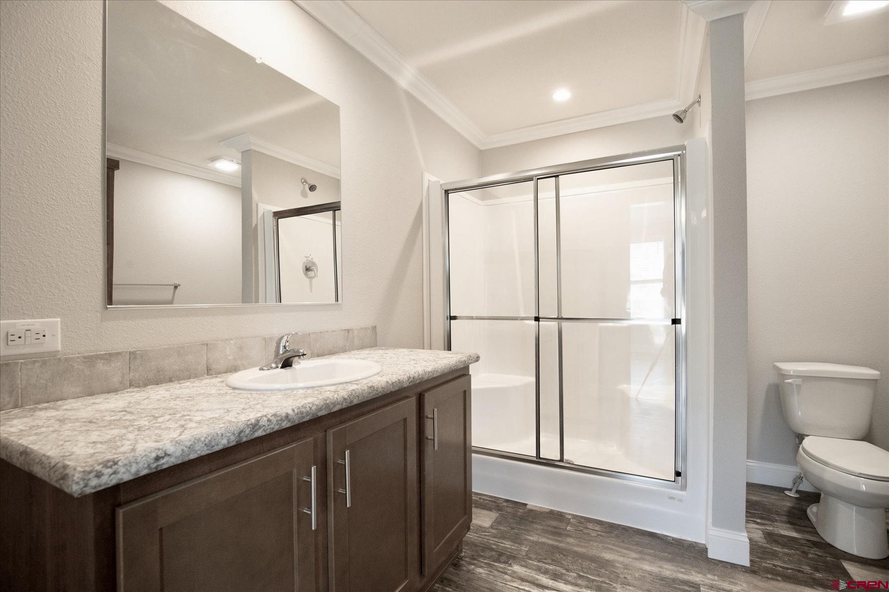 2229 Highway 160 Cortez, CO 81321 - Photo 15 of 32 a bathroom with a granite countertop sink and a mirror