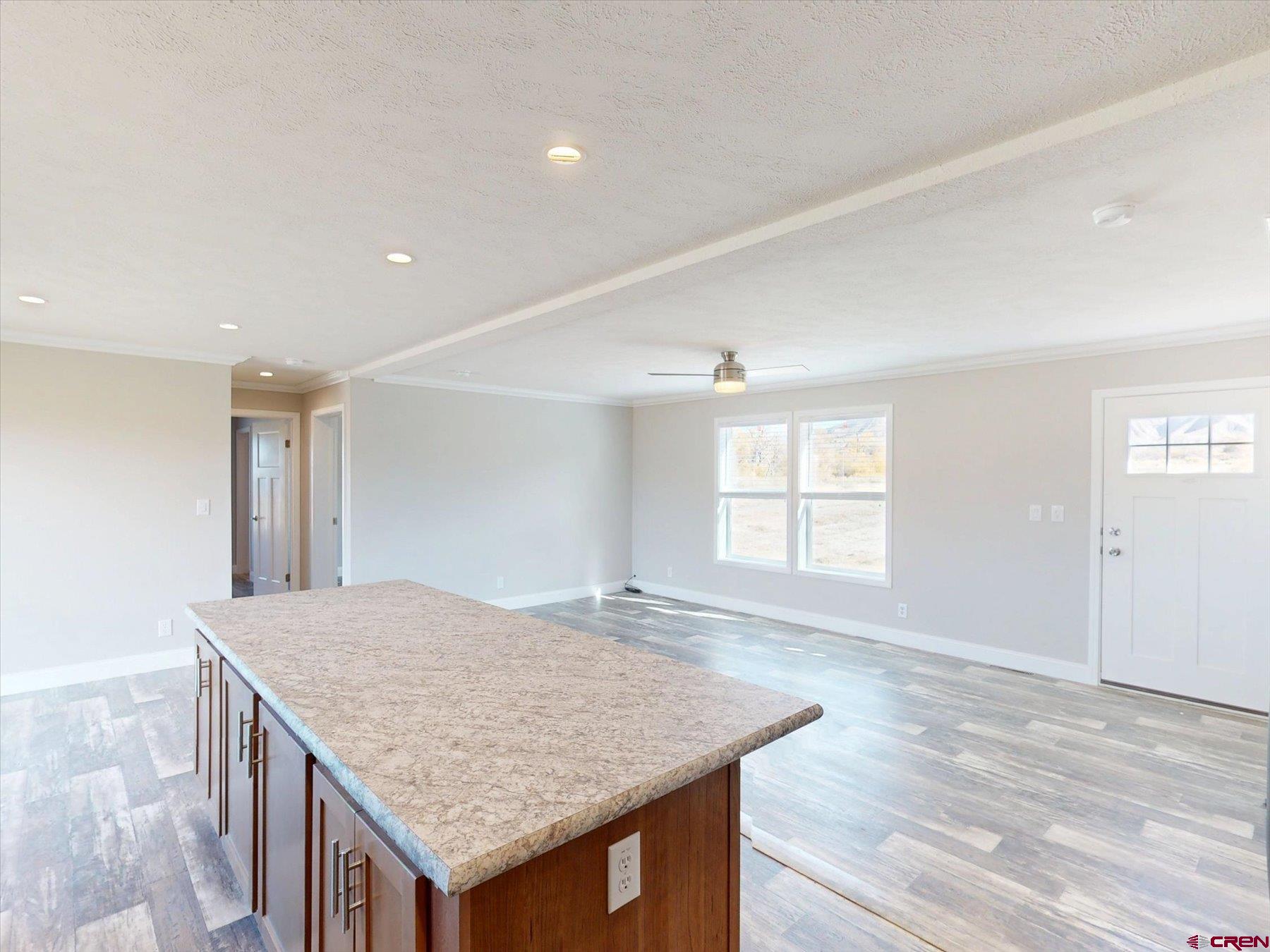 2229 Highway 160 Cortez, CO 81321 - Photo 18 of 32 an empty room with wooden floor and windows