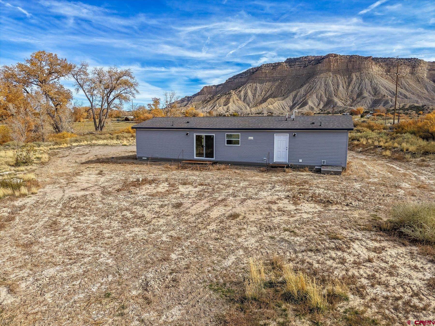 2229 Highway 160 Cortez, CO 81321 - Photo 2 of 32 a view of a house with a wooden fence