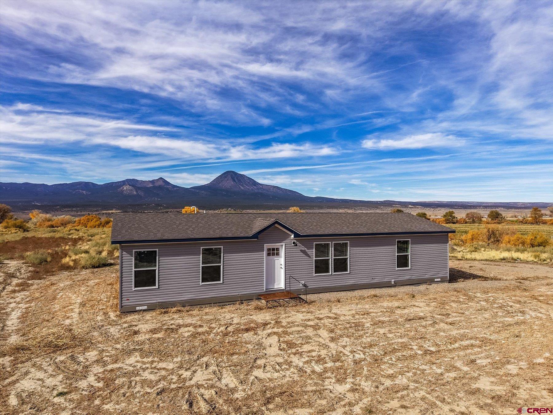 2229 Highway 160 Cortez, CO 81321 - Photo 24 of 32 front view of a house with a yard