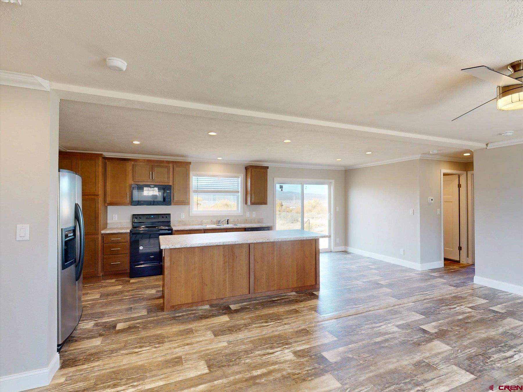2229 Highway 160 Cortez, CO 81321 - Photo 5 of 32 a view of kitchen with refrigerator stove and wooden floor