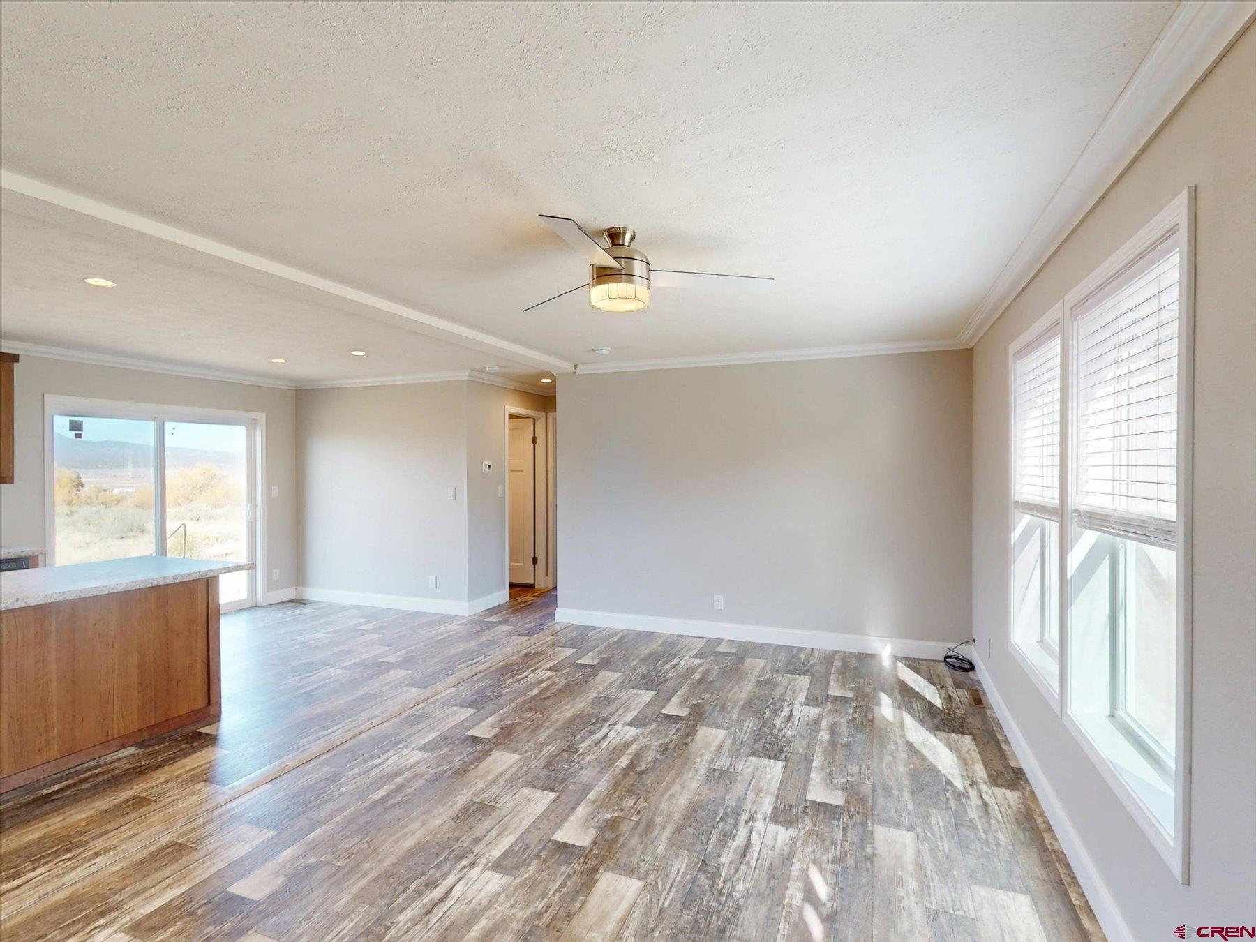 2229 Highway 160 Cortez, CO 81321 - Photo 6 of 32 an empty room with wooden floor and windows