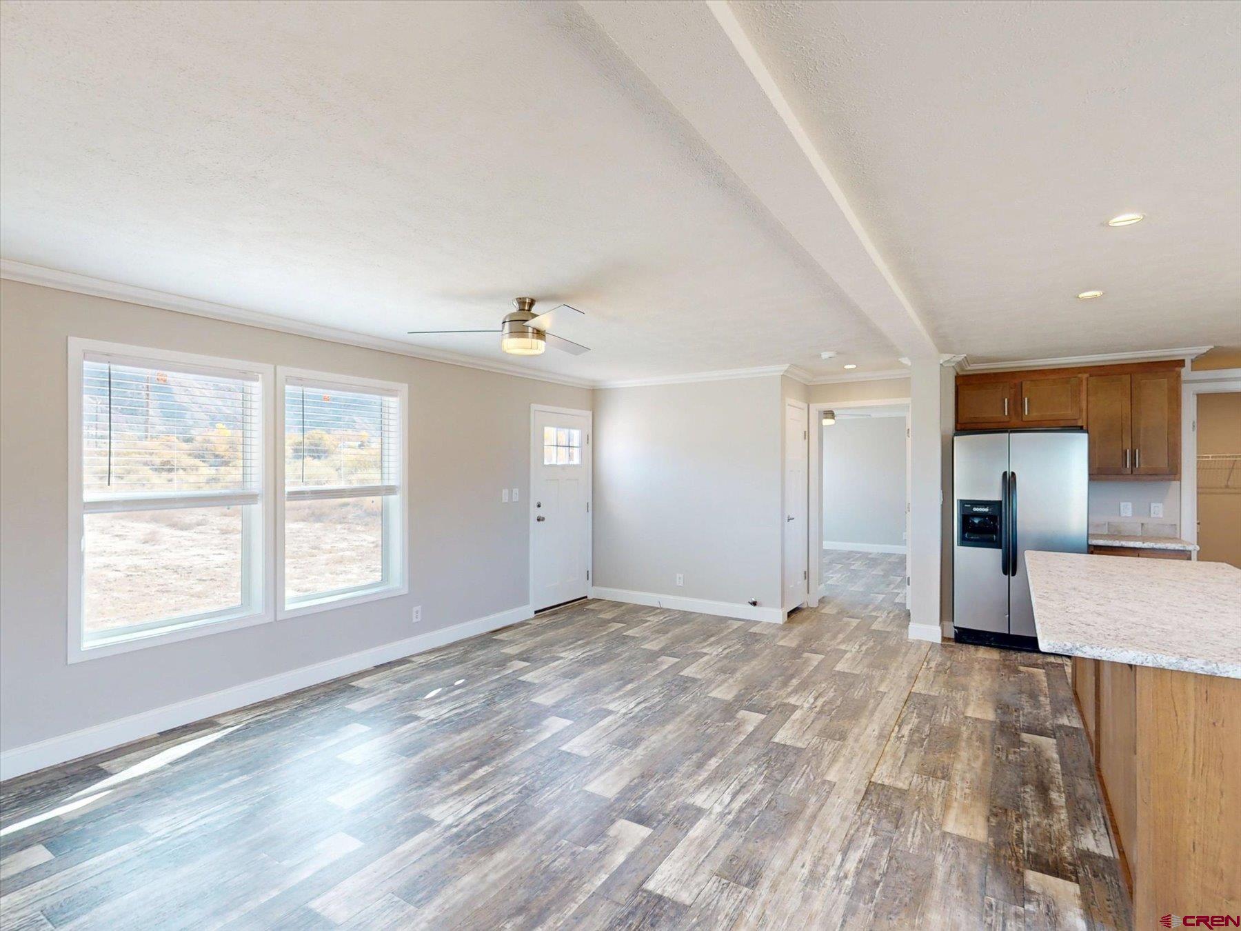 2229 Highway 160 Cortez, CO 81321 - Photo 7 of 32 a view of empty room with wooden floor and fan