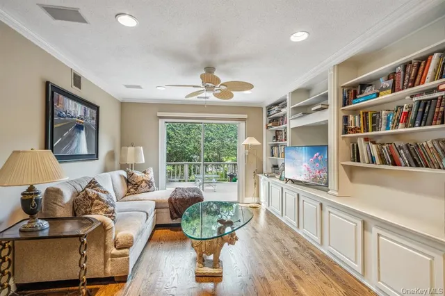 a living room with furniture and a book shelf