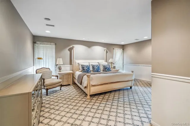 a bedroom with a bed and a chair