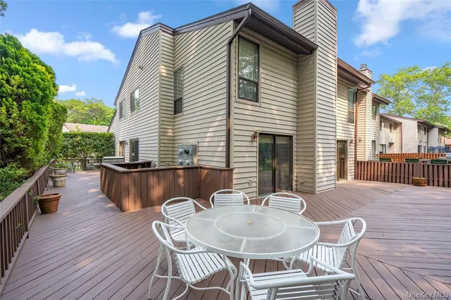 a balcony with table and chairs