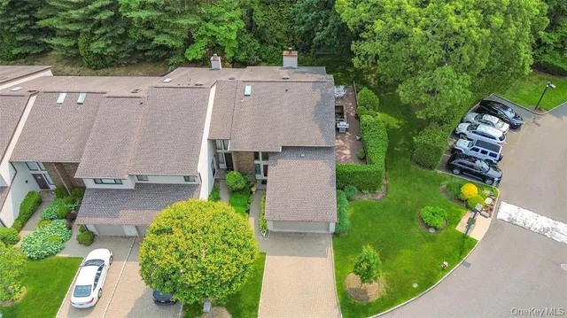 an aerial view of a house with garden space and street view