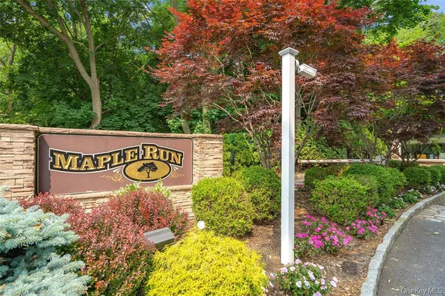 a sign broad in front of flowers