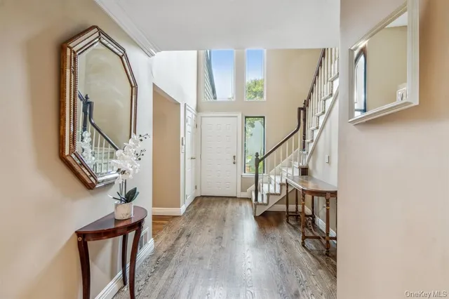 a view of an entryway with wooden floor and staircase