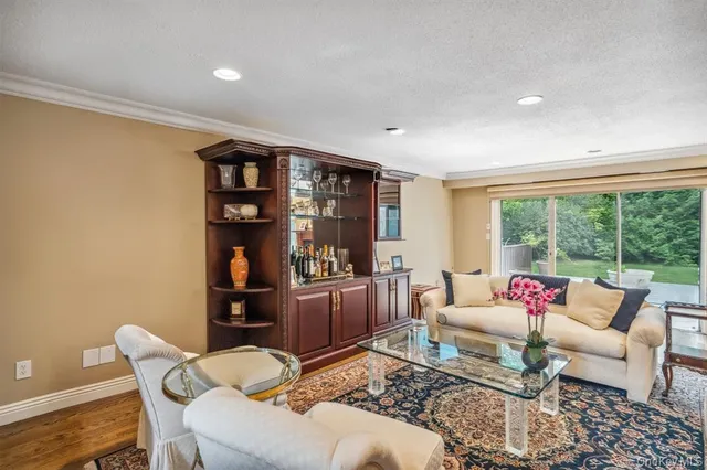a living room with furniture and a floor to ceiling window