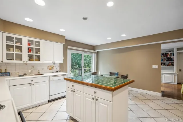 a kitchen with granite countertop a sink stove and cabinets