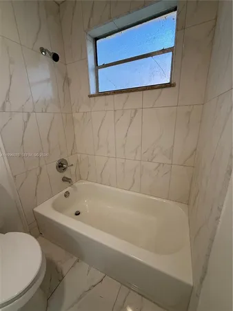 a bathroom with a bathtub and a toilet