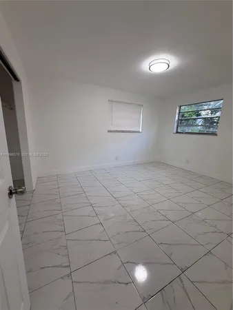 a view of an empty room and a window
