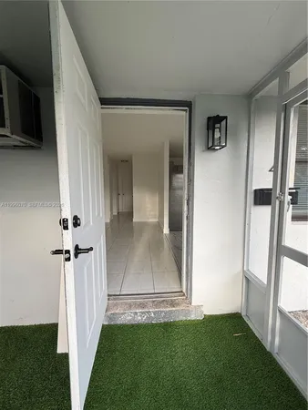 a view of a hallway with a white walls and stairs