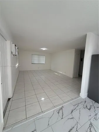 a view of an empty room and a window