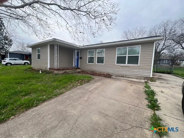 a front view of a house with a yard and a garage