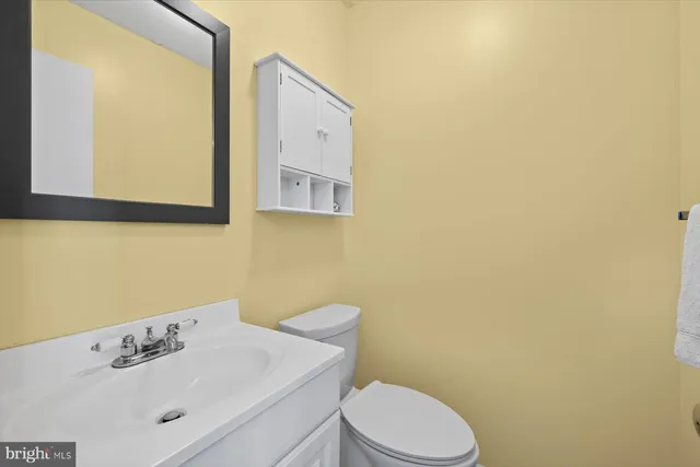 a bathroom with a sink mirror and toilet